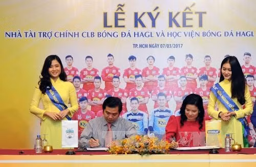 Đại diện nhà tài trợ với cầu thủ Nguyễn Công Phượng tại Lễ ký kết. Ảnh: An Hiếu - TTXVN
