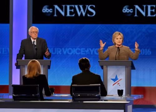 Trong ảnh: Ứng viên Bernie Sanders (trái) và Hillary Clinton trong cuộc tranh luận lần thứ 3 của các ứng cử viên Đảng Dân chủ tham gia tranh cử Tổng thống Mỹ năm 2016 tại Manchester, bang New Hampshire ngày 19/12. AFP/ TTXVN