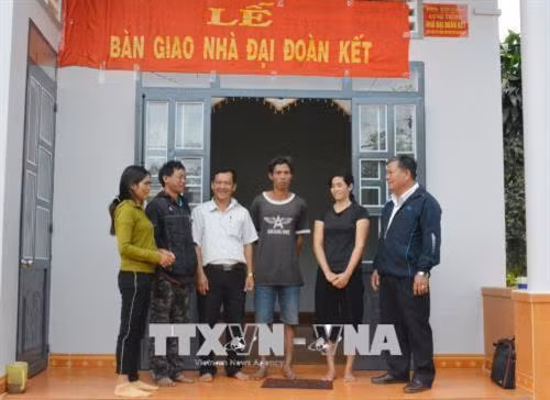 Trong năm 2017, từ nguồn quỹ “Vì người nghèo”, Ủy ban Mặt trận Tổ quốc Việt Nam tỉnh Đắk Lắk đã hỗ trợ xây mới 178 nhà đại đoàn kết cho hộ nghèo với tổng kinh phí hơn 4,5 tỷ đồng. Trong dịp Tết Mậu Tuất năm 2018, nhiều người nghèo của tỉnh Đắk Lắk sẽ được đón Tết trong nhà đại đoàn kết. Trong ảnh: Chị H’Dlit Êban (thứ 2 từ phải qua) phấn khởi được đón Tết Nguyên đán trong nhà đại đoàn kết khang trang. Ảnh: Tuấn Anh – TTXVN