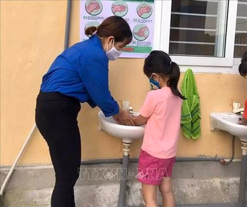 Hướng dẫn học sinh rửa tay sát khuẩn trước khi vào lớp tại trường học ở huyện miền núi Như Thanh, tỉnh Thanh Hóa. Ảnh: Nguyễn Nam-TTXVN