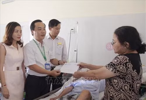 Nhân viên công tác xã hội Bệnh viện Quận 2 (Thành phố Hồ Chí Minh) cùng mạnh thường quân trao hỗ trợ cho người bệnh. Ảnh: Đinh Hằng - TTXVN