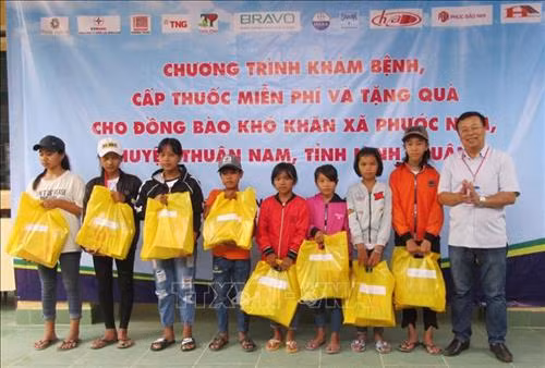 Ông Phan Văn Đông, Phó Giám đốc, Chủ tịch Công Đoàn Cơ quan TTXVN Khu vực phía Nam tặng quà cho các em học sinh nghèo hiếu học ở xã Phước Nam (huyện Thuận Nam, Ninh Thuận). Ảnh: Nguyễn Thành – TTXVN