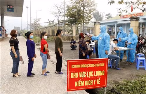 Người dân và hành khách được kiểm tra thân nhiệt tại chốt nút giao đường cao tốc Nội Bài - Lào Cai thuộc địa phận xã Xuân Giao, huyện Bảo Thắng (Km234). Ảnh: Quốc Khánh – TTXVN