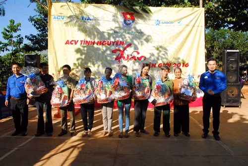 Đồng chí Võ Quốc Thắng (phải) - Bí thư đoàn thanh niên Cảng Hàng không quốc tế Tân Sơn Nhất tặng quà cho các gia đình có công với cách mạng, có hoàn cảnh khó khăn