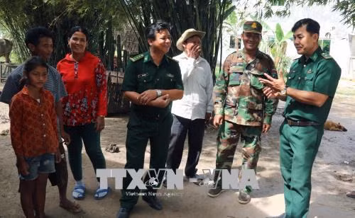 Cán bộ Đồn Biên phòng Phú Mỹ thăm hỏi, trao đổi với bà con, chính quyền địa phương tại ấp Tà Hưng, xã Pray Cơ Rớ, huyện Kampong Trach, (Vương quốc Campuchia). Ảnh: Lê Huy Hải - TTXVN