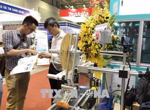 Đại diện các doanh nghiệp tìm hiểu các sản phẩm công nghệ mới tại hội chợ. Ảnh: Mỹ Phương – TTXVN