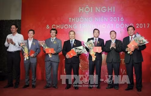 Trao tặng huy hiệu của Thành phố Hồ Chí Minh cho các cá nhân tiêu biểu tại Hội nghị. Ảnh: An Hiếu - TTXVN
