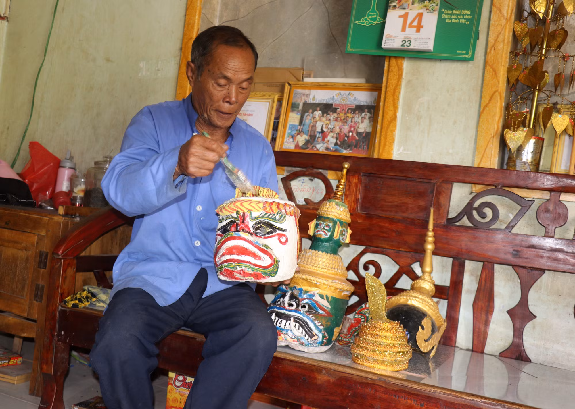 Nghệ nhân ưu tú Danh Bê giữ gìn, bảo quản đạo cụ biểu diễn. Ảnh: Lê Huy Hải – TTXVN