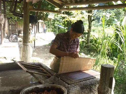 Bà con tạo khuôn giấy bản từ nước vỏ cây đã được quấy đều.