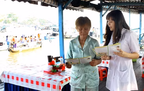 Nhân viên y tế tuyên truyền phòng chống sốt xuất huyết và dịch bệnh dovi rút Zika cho người dân làm ăn sinh sống trên tại chợ nổi Cái Răng (Cần Thơ). Ảnh: Dương Ngọc – TTXVN