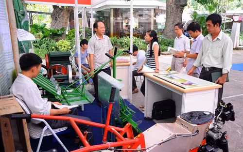 Khách thăm quan máy cấy lúa không dùng động cơ của ông Trần Đại Nghĩa ở xã Đông Hoàng, huyện Tiền Hải (Thái Bình). Ảnh: Quang Quyết-TTXVN