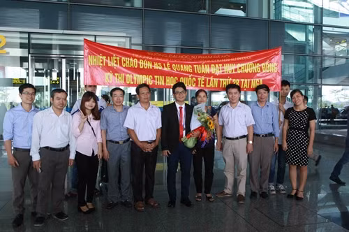 Người thân cùng thầy, cô giáo tặng hoa chúc mừng em Lê Quang Tuấn, học sinh lớp 11, Trường Trung học phổ thông chuyên Đại học Sư phạm Hà Nội đoạt Huy chương Đồng. Ảnh: Quý Trung – TTXVN