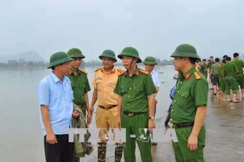 Ông Nguyễn Quốc Tuấn - Trưởng công an huyện Nho Quan thị sát tình hình đắp bờ bao cho tuyến đê. Ảnh: Minh Đức - TTXVN