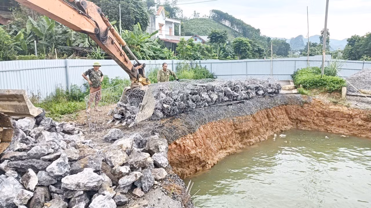 Đơn vị thi công đang làm rọ đá để thả xuống "hố tử thần". Ảnh TTXVN phát