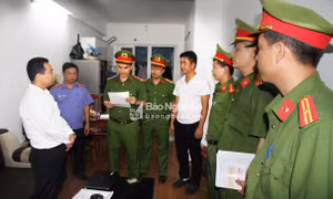 Lực lượng chức năng đọc lệnh bắt ông Kim Văn Bốn. Ảnh: baonghean.vn