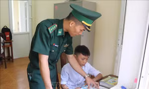 Chiến sĩ Đồn Biên phòng Pa Thơm (Bộ đội Biên phòng tỉnh Điện Biên) trực tiếp tiếp kèm cặp, hỗ trợ các cháu con nuôi của đơn vị học tập hằng ngày trong góc học tập riêng của các cháu. Ảnh: Xuân Tiến – TTXVN