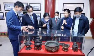 Các đại biểu nghe thuyết minh về những tư liệu quý tại Triển lãm. Ảnh: Anh Tuấn - TTXVN