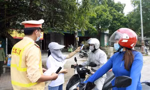 Kiểm tra thân nhiệt chủ phương tiện tại chốt kiểm soát dịch bệnh COVID-19 ở địa điểm cổng chào thành phố Vĩnh Yên giáp với huyện Vĩnh Tường (Vĩnh Phúc). Ảnh: Hoàng Hùng - TTXVN