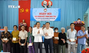 Lãnh đạo tỉnh Vĩnh Long tặng quà cho gia đình chính sách. Ảnh: Phạm Minh Tuấn - TTXVN