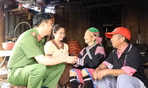 Thượng tá Hà Thái Hoàn, Trưởng Công an thành phố Lai Châu và lãnh đạo xã Sùng Phài chia sẻ khó khăn của vợ chồng ông Giàng A Súa khi phải ở trong lều tre. Ảnh: Đinh Thùy - TTXVN 