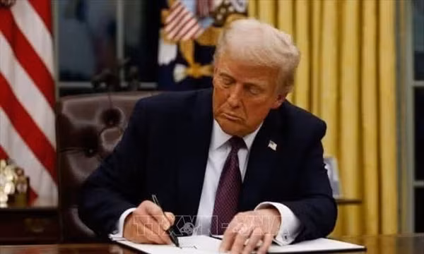 Tổng thống Mỹ Donald Trump ký sắc lệnh tại Nhà Trắng. Ảnh: Getty Images/TTXVN