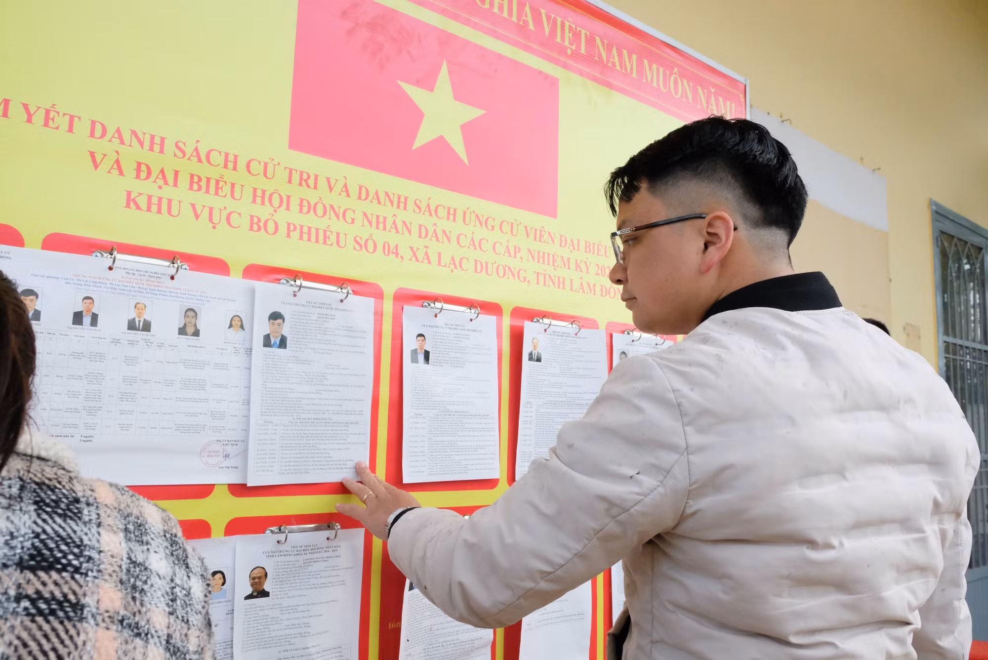 Cử tri theo dõi thông tin trên danh sách các ứng cử viên đại biểu Quốc hội khóa XVI và đại biểu Hội đồng nhân dân các cấp tại khu vực bỏ phiếu số 4 (xã Lạc Dương, Lâm Đồng).
