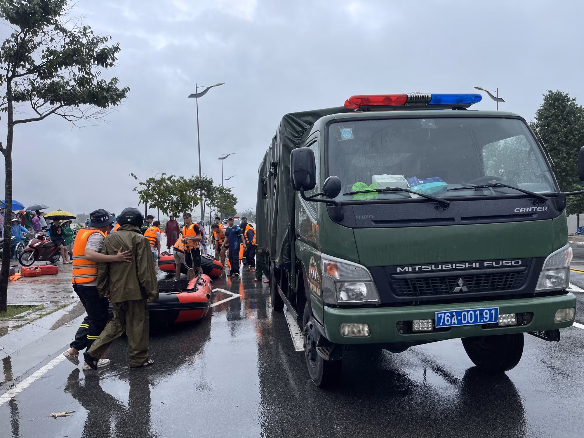 Lực lượng Cảnh sát phòng cháy chữa cháy Công an tỉnh Quảng Ngãi chuẩn bị phương tiện đưa người dân giữa dòng sông Trà Khúc vào bờ. Ảnh: TTXVN