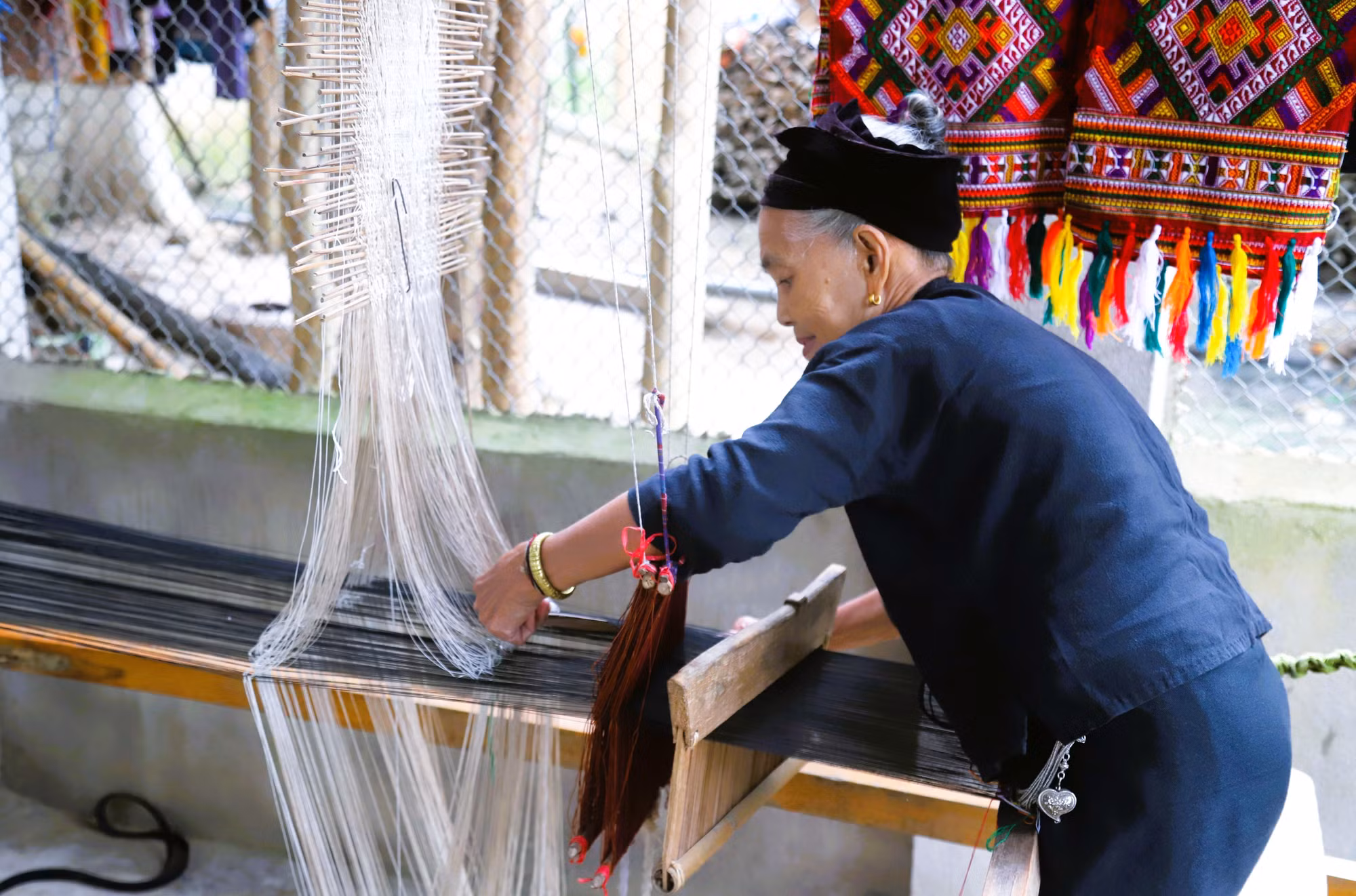 Mỗi ngày, bà Vi Thị Dung thường dành thời gian miệt mài bên khung cửi.