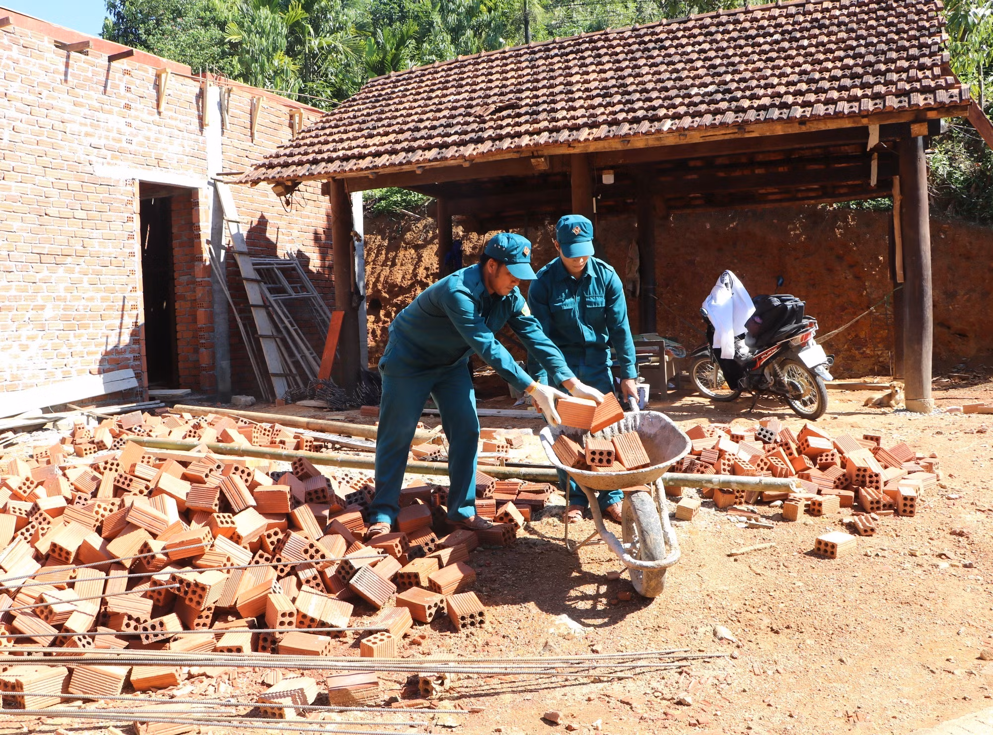 Lực lượng dân quân tự vệ hỗ trợ bà con xây dựng, sửa chữa nhà.