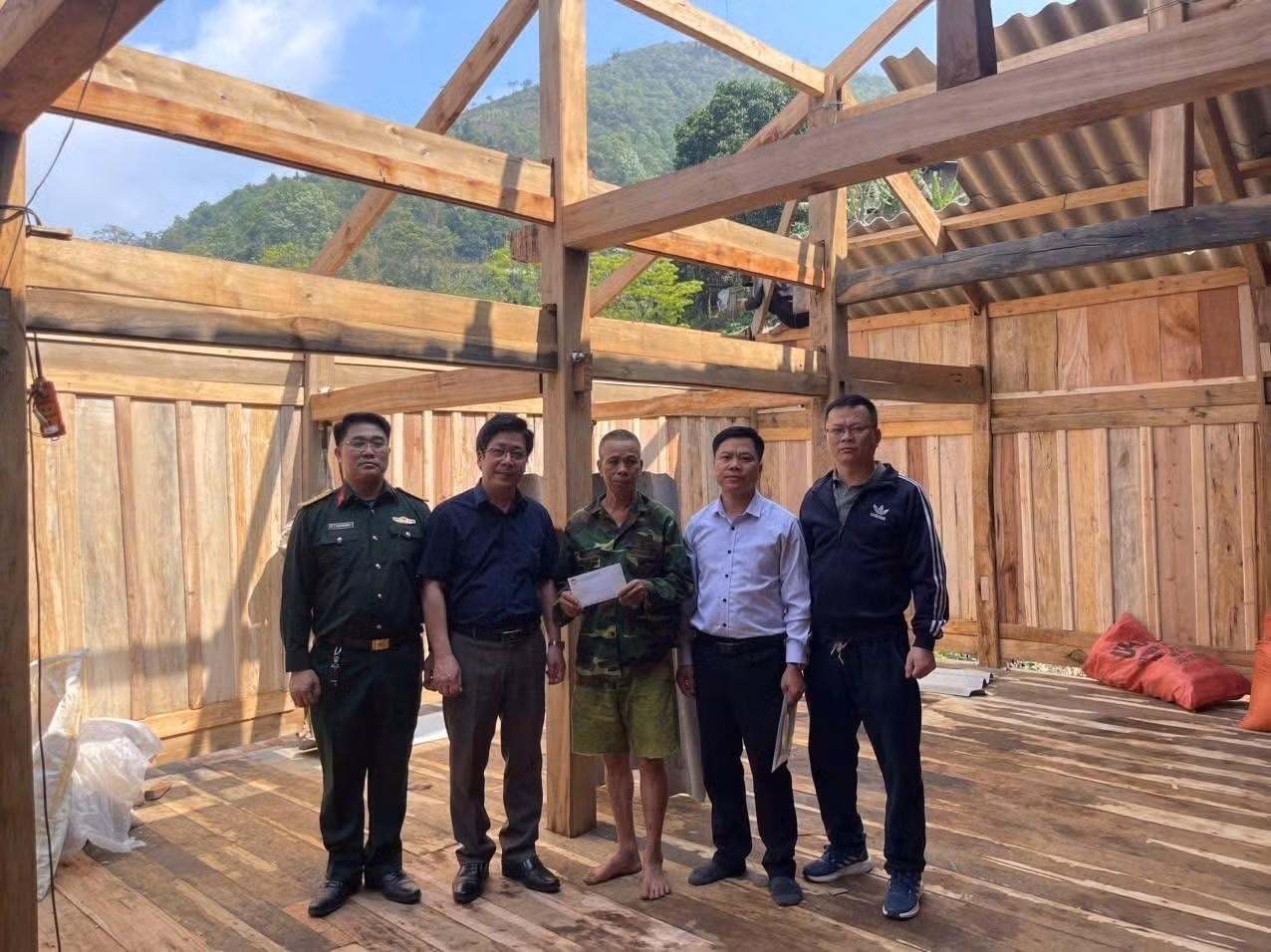 Lực lượng chức năng hỗ trợ người dân sửa chữa căn nhà bị tốc mái do dông lốc, mưa đá. Ảnh: TTXVN phát