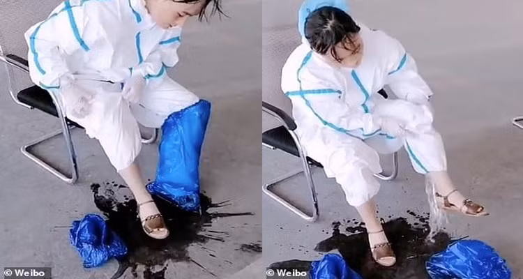 Mồ hôi trút ào thành vũng từ bộ đồ bảo hộ của nữ nhân viên y tế