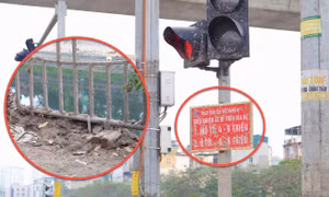Vỉa hè, biển báo giao thông lấm lem bùn đất sau nạo vét sông Tô Lịch