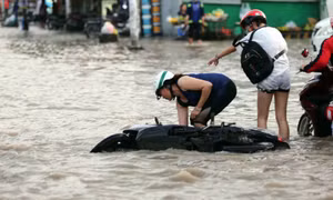Triều cường đạt đỉnh, người đi xe máy ngã nhào trong biển nước