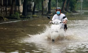 Người dân Hà Nội di chuyển khó khăn sau cơn mưa lớn cuối giờ chiều