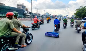 Lực lượng Công an phường Trung Mỹ Tây cùng Đoàn thanh niên phường chạy xe hút đinh trên Quốc lộ 1 đoạn qua địa bàn Quận 12.